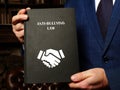 ANTI-BULLYING LAW book in the hands of a jurist. Anti-bullying lawsÃÂ are one prevention strategy that can change social norms